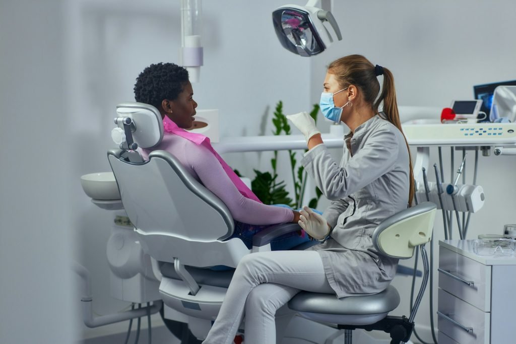 Dentist and african patient at clinic