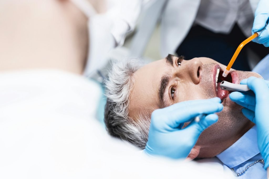 Man having root canal put stock photo